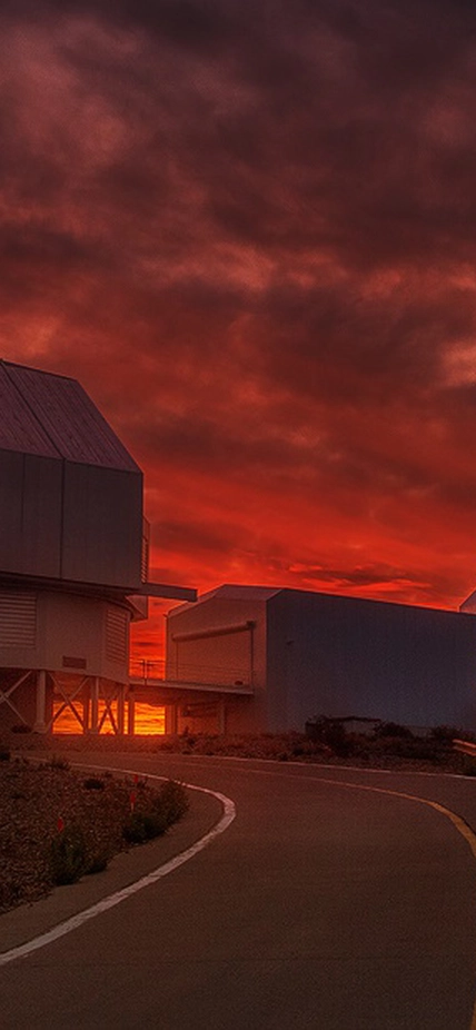 Sunset reddens the sky behind the Magellan telescopes at Carnegie's Las Campanas Observatory in Chile. 